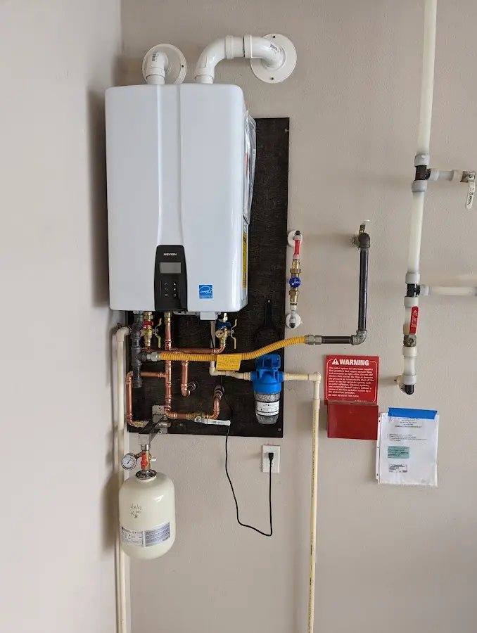 Professional plumber installing copper piping in a Wolf home